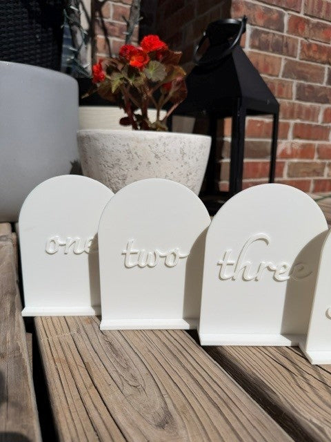 White arch table numbers group display for wedding and event table decor