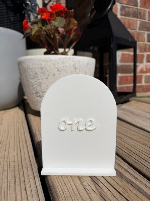 Single white arch table number for elegant wedding reception or party