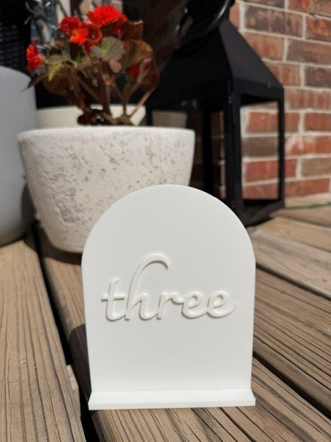 White arch table number 3 for wedding reception, party, or corporate event decor
