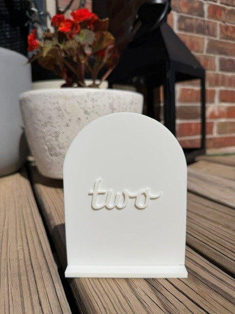 White arch table number 2 standing upright for event or wedding table setting